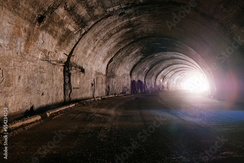 Old underground road tunnel inside mountain. Light at the end of tunnel © Mulderphoto