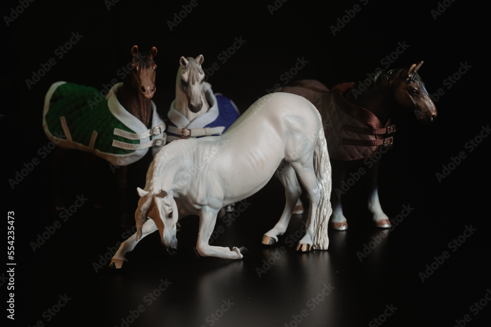 Black toy horse isolated on black background Black toy horse isolated on black background