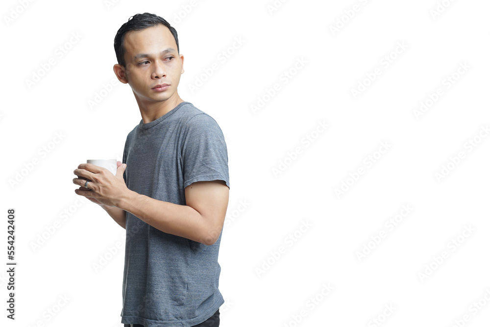 handsome asian man holding cup of coffee on isolated background handsome asian man holding cup of coffee on isolated background