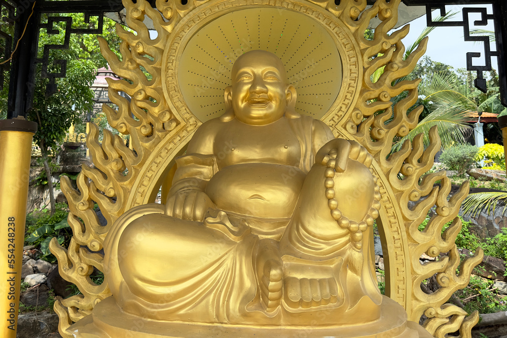 Asian Buddhist golden statues in a garden temple in Vietnam