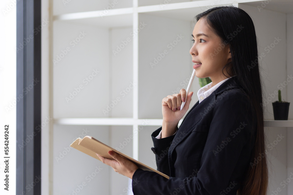 Portrait of an attractive Asian secretary or businesswoman in the office. Portrait of an attractive Asian secretary or businesswoman in the office.