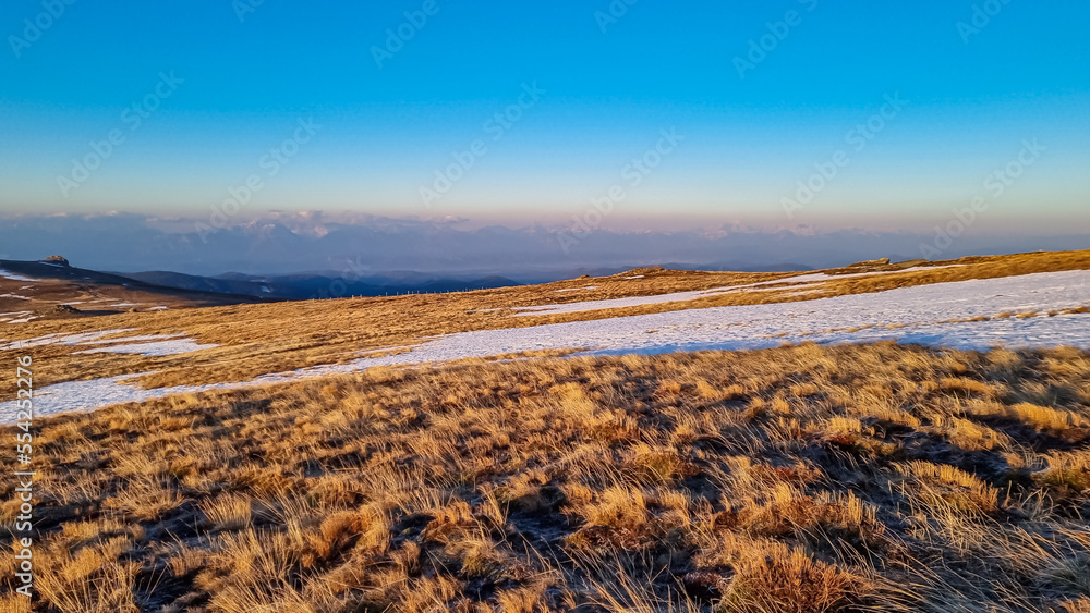 Scenic view of snow covered alpine meadows and Karawanks mountains seen from Ladinger Spitz, Saualpe, Lavanttal Alps, Carinthia, Austria, Europe. Hiking trails at morning golden hour, Wolfsberg region Scenic view of snow covered alpine meadows and Karawanks mountains seen from Ladinger Spitz, Saualpe, Lavanttal Alps, Carinthia, Austria, Europe. Hiking trails at morning golden hour, Wolfsberg region