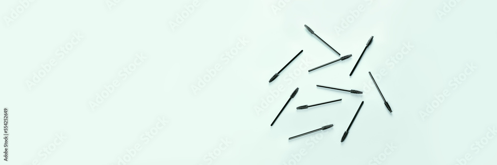Set of brushes for eyelashes and eyebrows on blue background. Correction and care. Cooling and laying. Womens cosmetics. Banner. Set of brushes for eyelashes and eyebrows on blue background. Correction and care. Cooling and laying. Womens cosmetics. Banner.