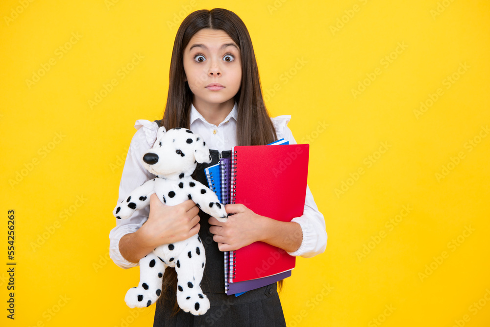 Funny school girl with toy. Happy childhood and kids education. Knowledge day. Surprised face, surprise emotions of teenager girl. Funny school girl with toy. Happy childhood and kids education. Knowledge day. Surprised face, surprise emotions of teenager girl.