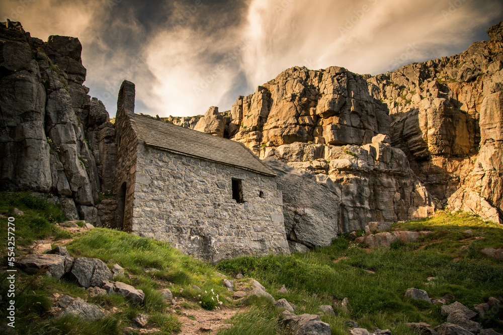 St Govans chapel at sunset, situated between two cliffs in Pembrokeshire, Wales
