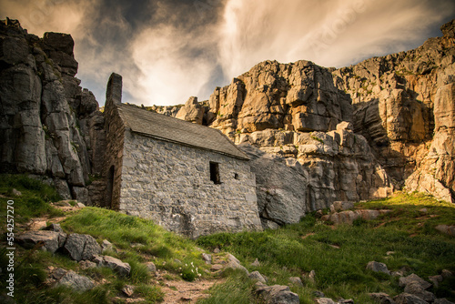 St Govans chapel at sunset, situated between two cliffs in Pembrokeshire, Wales photo