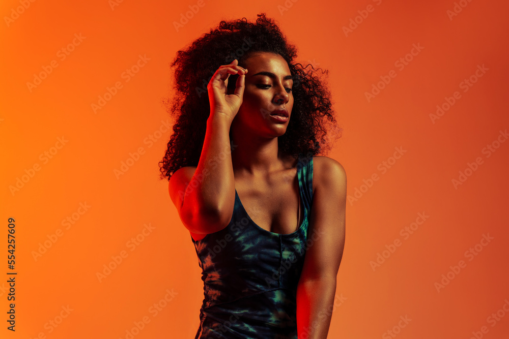 Ethnic woman looking down touching forehead Ethnic woman looking down touching forehead