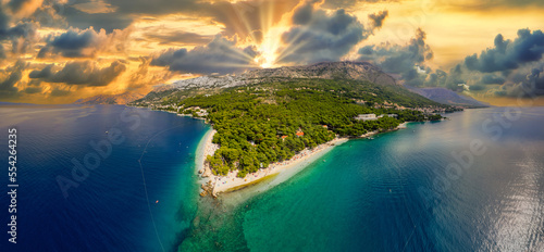 Fototapeta Naklejka Na Ścianę i Meble -  Beautiful gravel beach with Biokovo mountains on background and stunning colorful sunset,Brela,Makarska riviera,Dalmatia,Croatia,Europe
