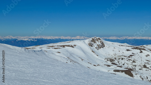 Scenic view of snow covered alpine hills on hiking trail from Ladinger Spitz to Gertrusk, Saualpe, Lavanttal Alps, Carinthia, Austria, Europe. Untouched field of snow. Ski touring snowshoeing tourism © Chris