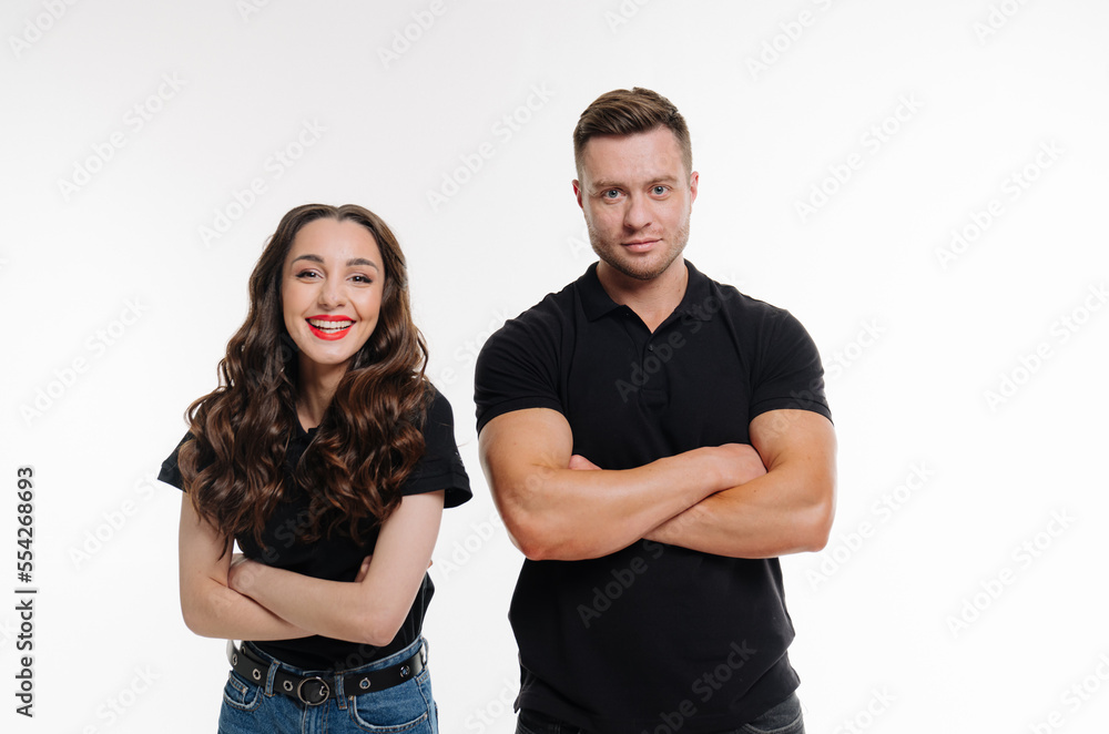 Cheerful happy man and woman with crossed hands standing against white studio background. Young couple posing on white background Cheerful happy man and woman with crossed hands standing against white studio background. Young couple posing on white background