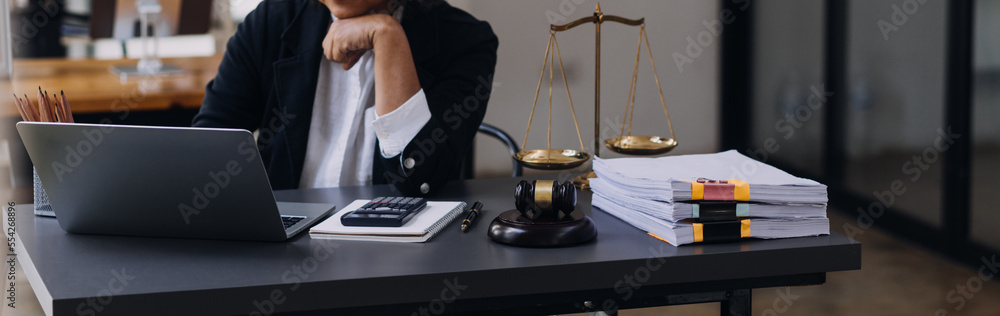 law books and scales of justice on desk in library of law firm. jurisprudence legal education concept. law books and scales of justice on desk in library of law firm. jurisprudence legal education concept.