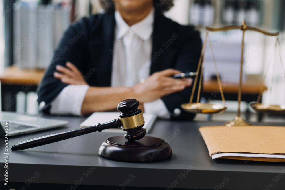 law books and scales of justice on desk in library of law firm. jurisprudence legal education concept. law books and scales of justice on desk in library of law firm. jurisprudence legal education concept.