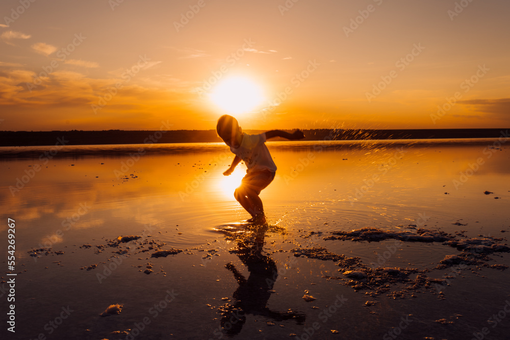 Silhouette of male child in sunlight rays.