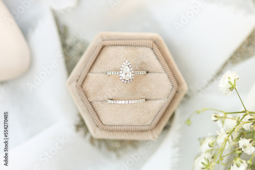 Bride diamond wedding ring and engagement band in a cream velvet ring box
