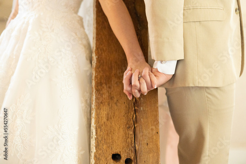 Bride and groom holding hands on their wedding day