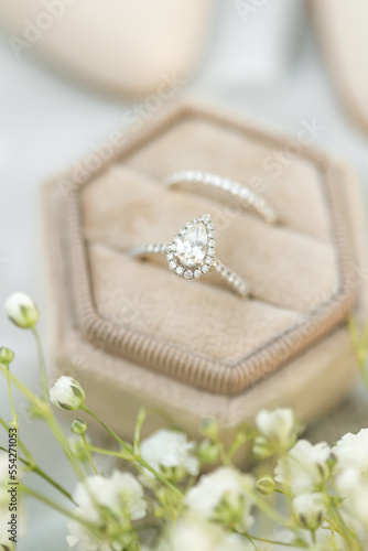 Bride diamond wedding ring and engagement band in a cream velvet ring box