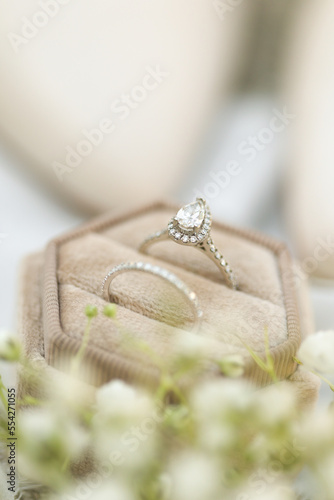 Bride diamond wedding ring and engagement band in a cream velvet ring box