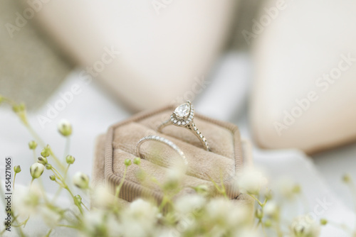 Bride diamond wedding ring and engagement band in a cream velvet ring box photo