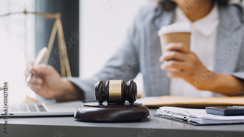 Photography law books and scales of justice on desk in library of law firm
