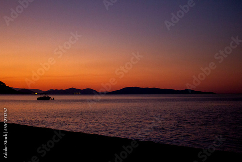 Sunset over calm ocean aerial panoramic view. Dramatic sunset seascape in Aegean Sea. Orange and blue color shades cloudy sky. Chalkidiki, Greece © BusinessImage