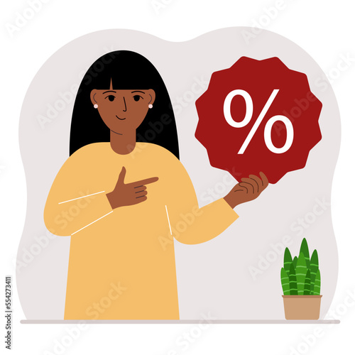 A woman holds a percent sign in his hand. The concept of percentage, discount, promotion, interest rate, percent discount in shopping.
