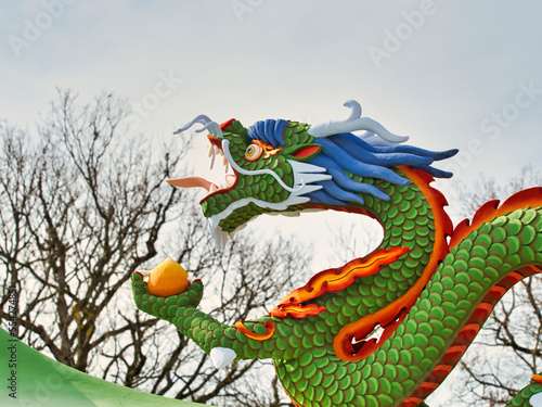 Close up of a colorful dragon on an rooftop of the one thousand buddhas temple  in France