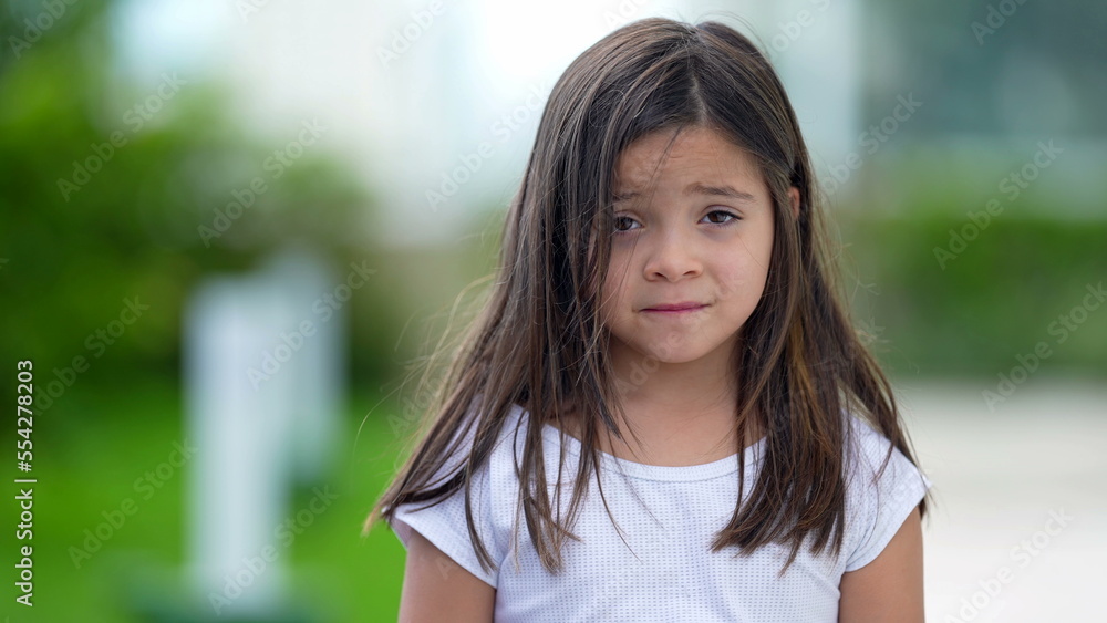 Portrait little girl with concerned emotion nervous child looking at camera Portrait little girl with concerned emotion nervous child looking at camera