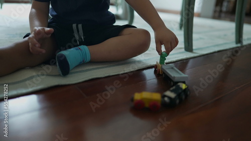 Little boy playing toys on home floor