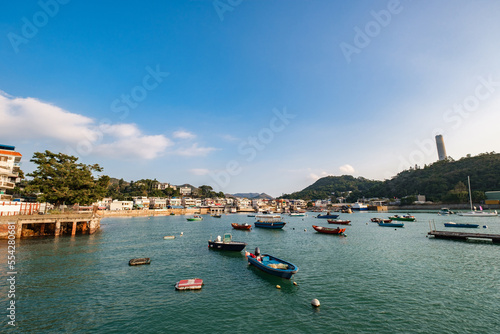 A row of traditional buildings in fishing village at Yung Shue Wan in Lamma Island, with boats in the foreground photo