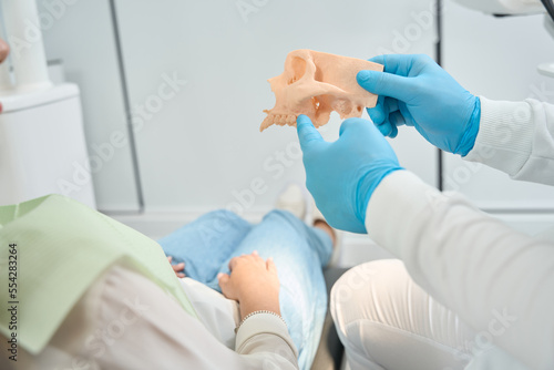 Stomatologist is telling about upper jawbone density to client photo