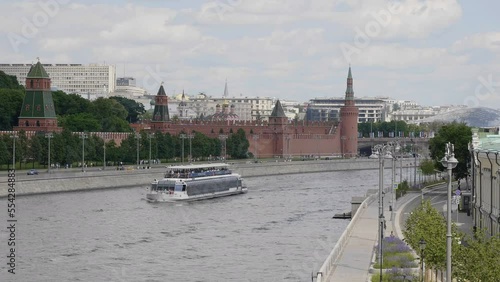 View of the Moscow Kremlin from the Moscow river. Red brick towers and Bell Tower Of Ivan The Great.