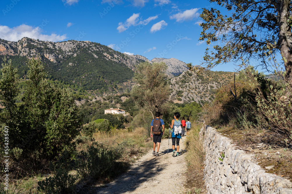 hikers coming to town, Orient valley , Bunyola, Majorca, Balearic Islands, Spain