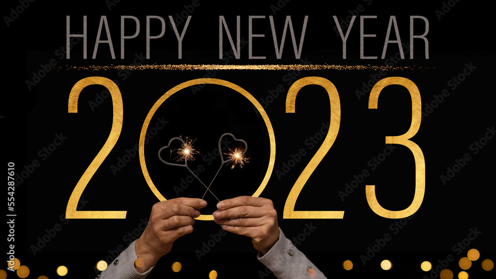 2023 Happy New Year holiday Greeting Card banner background - Young woman holds sparklers in her hands, golden year with text on black night sky 2023 Happy New Year holiday Greeting Card banner background - Young woman holds sparklers in her hands, golden year with text on black night sky