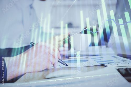 Double exposure hands with stock market chart.