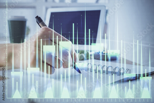 Financial forex graph drawn over hands taking notes background. Concept of research. Multi exposure © peshkova