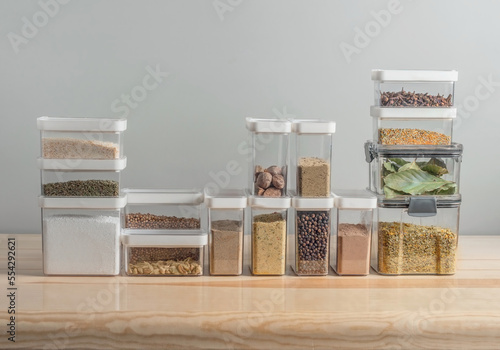 plastic containers with dry spices on a kitchen