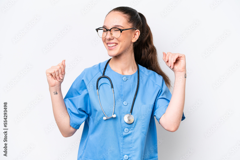 Young caucasian surgeon doctor woman isolated on white background celebrating a victory Young caucasian surgeon doctor woman isolated on white background celebrating a victory