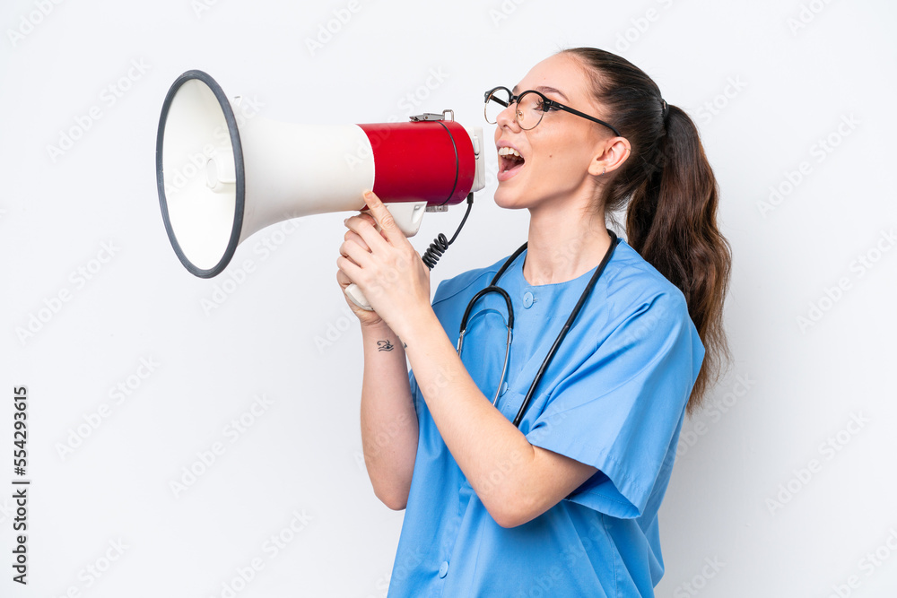 Young caucasian surgeon doctor woman isolated on white background shouting through a megaphone Young caucasian surgeon doctor woman isolated on white background shouting through a megaphone
