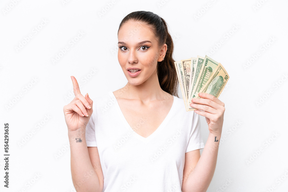 Young caucasian woman taking a lot of money isolated on white background thinking an idea pointing the finger up Young caucasian woman taking a lot of money isolated on white background thinking an idea pointing the finger up