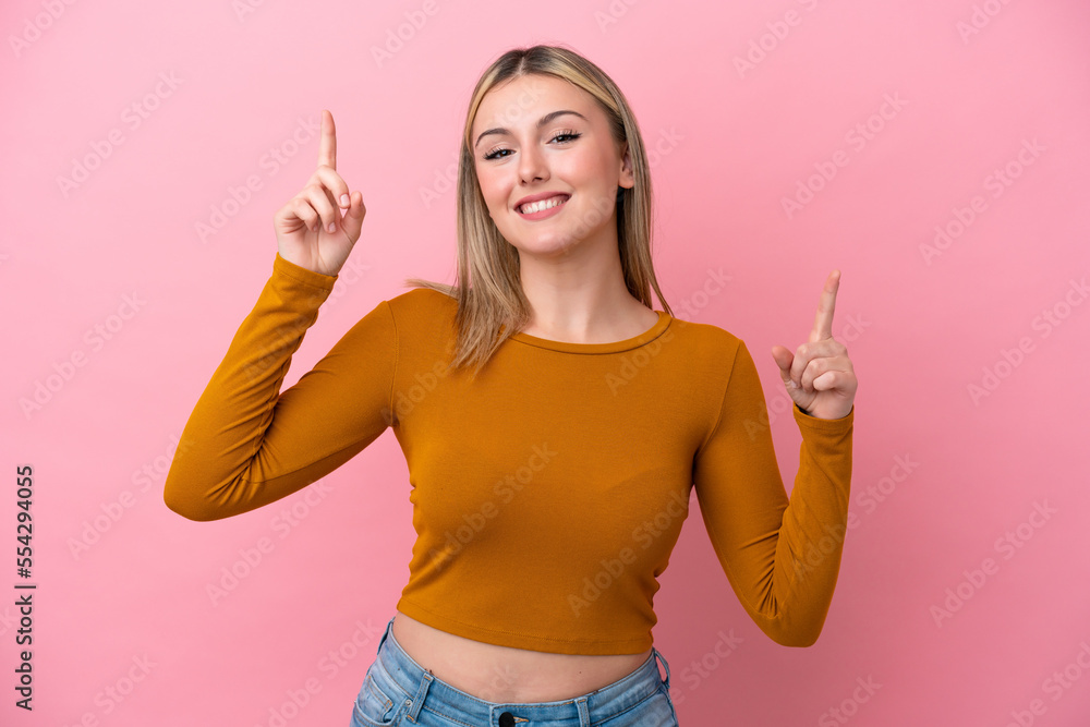 Young caucasian woman isolated on pink background pointing up a great idea Young caucasian woman isolated on pink background pointing up a great idea