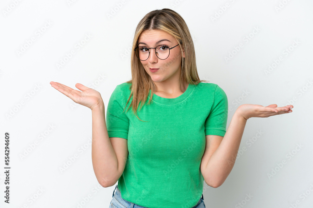 Young caucasian woman isolated on white background having doubts while raising hands Young caucasian woman isolated on white background having doubts while raising hands