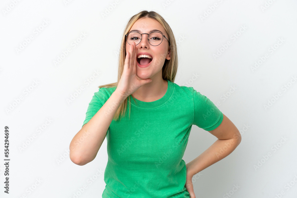 Young caucasian woman isolated on white background shouting with mouth wide open Young caucasian woman isolated on white background shouting with mouth wide open
