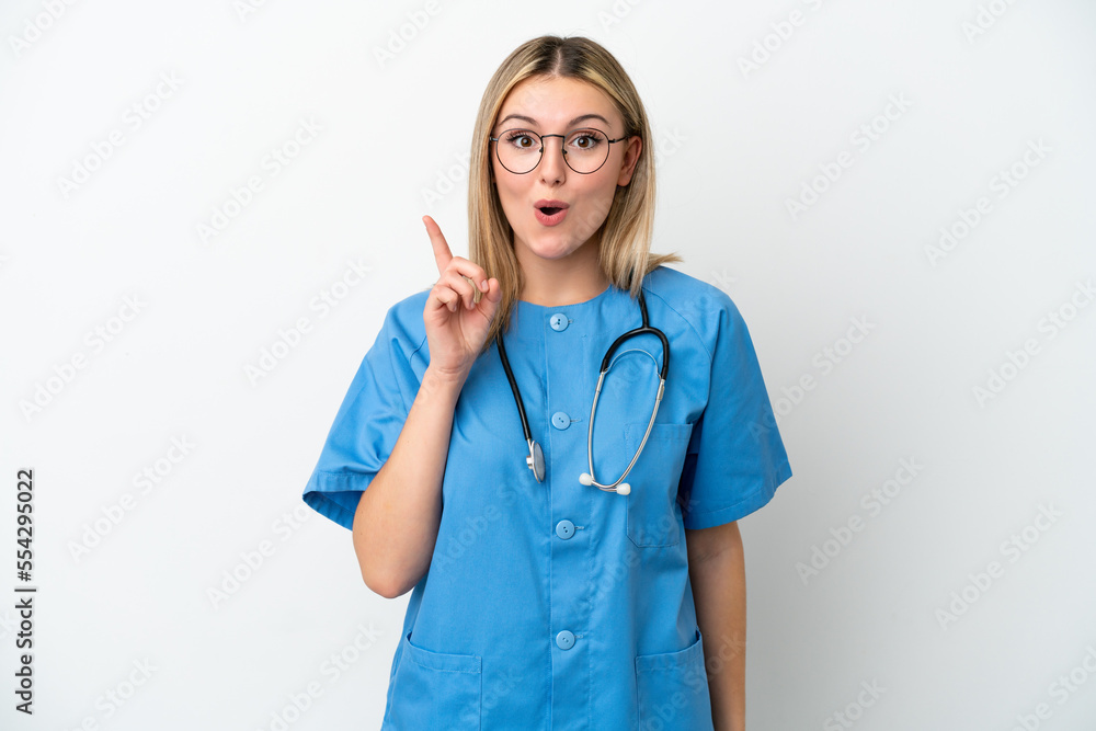Young surgeon doctor woman isolated on white background intending to realizes the solution while lifting a finger up Young surgeon doctor woman isolated on white background intending to realizes the solution while lifting a finger up