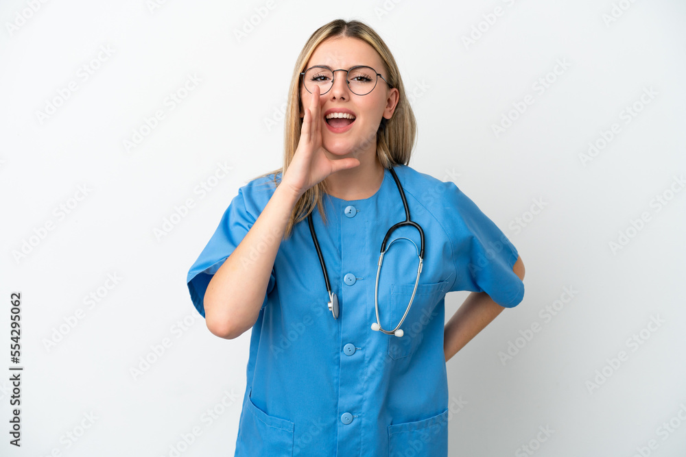 Young surgeon doctor woman isolated on white background shouting with mouth wide open Young surgeon doctor woman isolated on white background shouting with mouth wide open