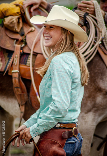 Fotografía A lovely young cowgirl in the staging area  preparing for her ride in the Cowboy Symposium Parade of the Horse