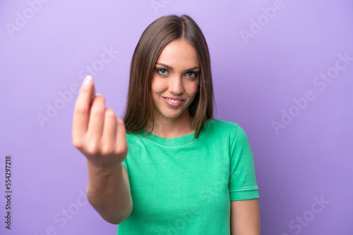 Wallpaper Mural Young caucasian woman isolated on purple background doing coming gesture Torontodigital.ca
