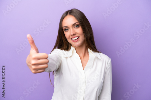 Wallpaper Mural Young caucasian woman isolated on purple background with thumbs up because something good has happened Torontodigital.ca
