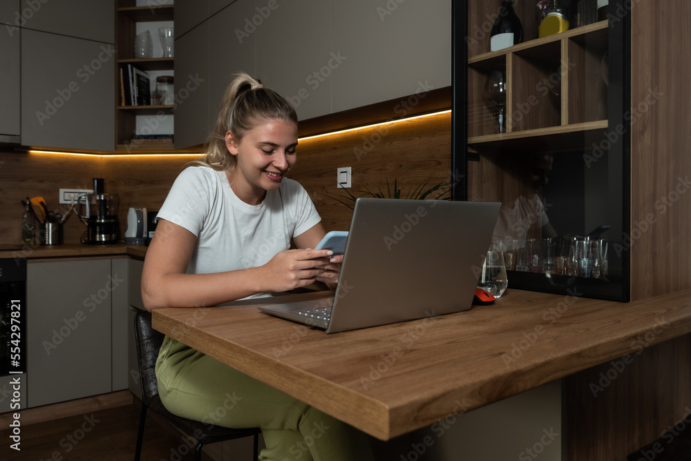 Young woman computer programmer software developer and web designer working from home as freelancer. Business female interior designer work on new project on her laptop computer from home. Young woman computer programmer software developer and web designer working from home as freelancer. Business female interior designer work on new project on her laptop computer from home.