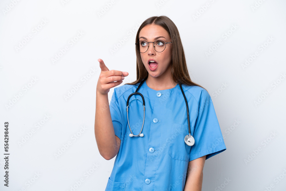 Young nurse caucasian woman isolated on white background pointing away Young nurse caucasian woman isolated on white background pointing away