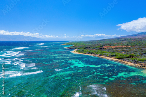 Aerial view of the coast of Shipwreck Beach in Lanai with turquoise water and ocean waves rolling into the shore; Lanai, Hawaii, United States of America